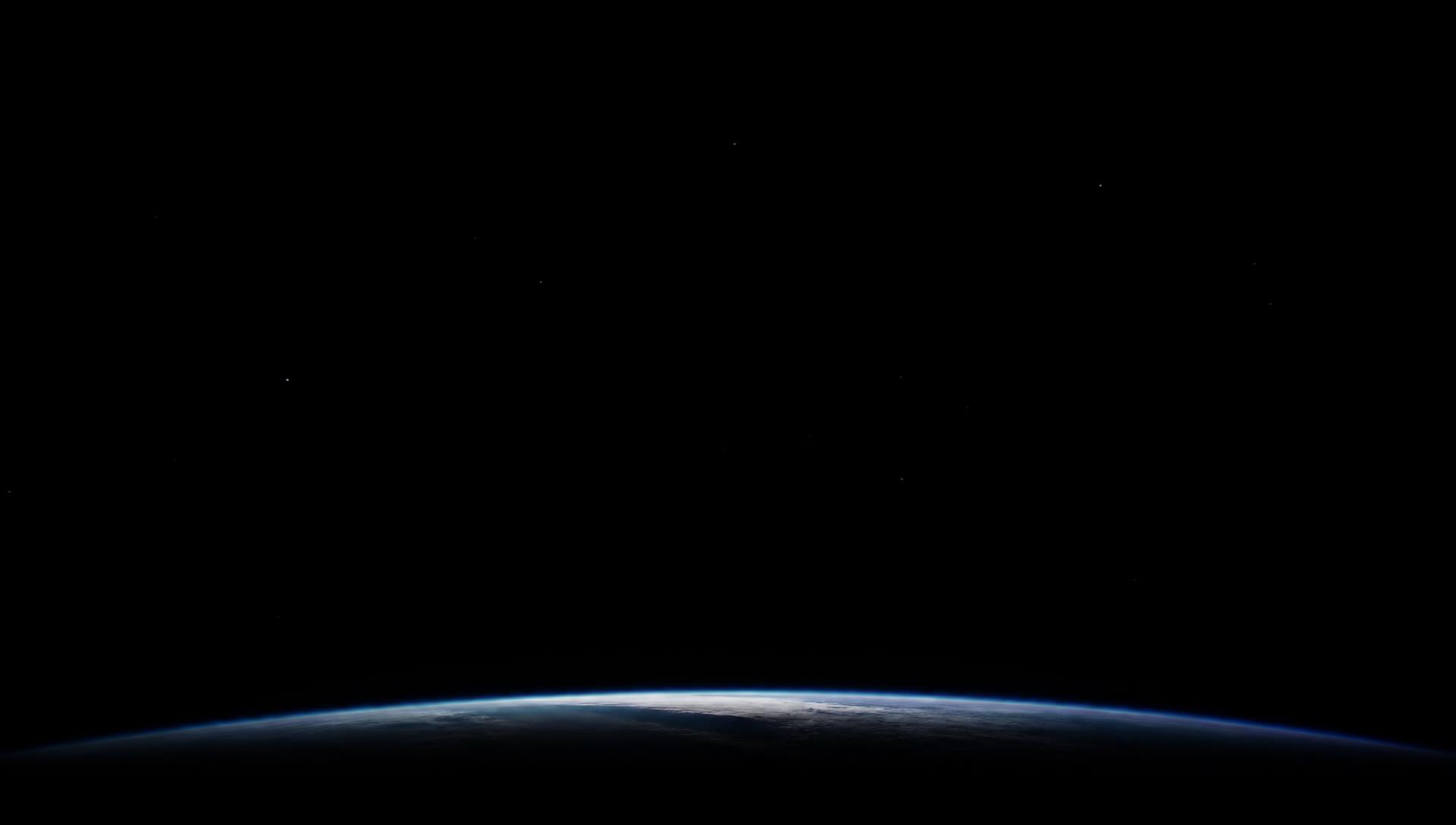 Earth's thin illuminated horizon against deep space